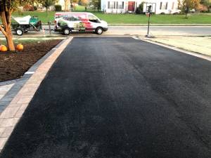 Finished custom residential driveway with work van