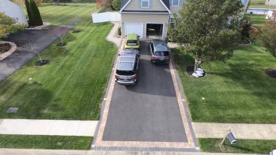 Unique asphalt driveway with brick border