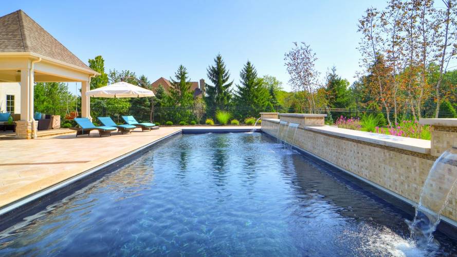 Volcanic black colored imagine pool installed, rectangular with foutains